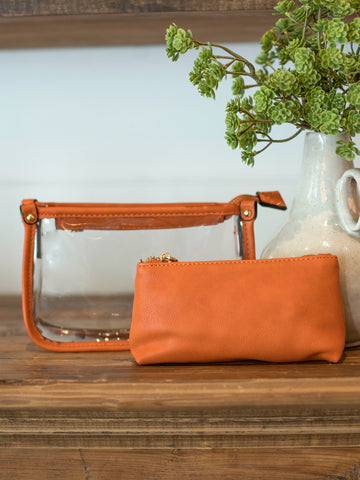 this clear bag with chain and crossbody strap comes in orange vegan leather and includes a matching inner bag