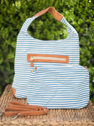 blue and white striped canvas bag in hobo silhouette with zip pocket and and removable inner bag with crossbody strap