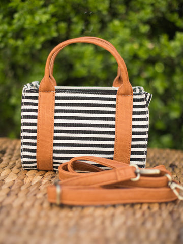 mini handbag with top handles black and white stripes and removable crossbody strap trimmed with vegan leather