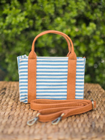 mini handbag with top handles blue and white stripes and removable crossbody strap trimmed with vegan leather