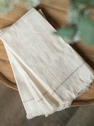 natural ivory white square napkins made of 100% cotton with delicate embroidery and fringe edge detail