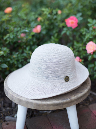 a crushable half brim sun hat in light beige with upf 50 and an interior adjustable velcro band for a better fit