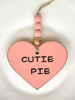 decorate your car or home with this coral valentines ornament that reads cutie pie with wooden beads as whimsical decor