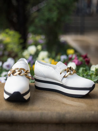 slip on platform sneakers white with black stripe with gold chain link buckle and made of soft suede and leather side view