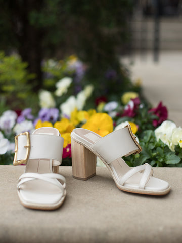 city ivory white slip on wood block heel sandals made of vegan leather with oversized gold buckles wide straps and square toe side view