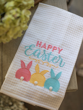 cotton white waffle weave decorative hand towel with blue yellow and pink bunny pom appliqued design reads happy easter