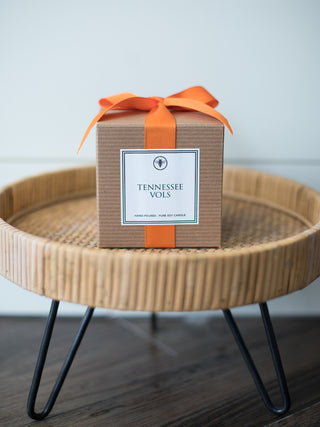 a gift box with an orange ribbon and tennessee vols printed on the side