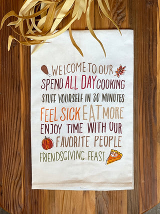 a white tea towel with sweet sentiments about friendsgiving and printed food drawings for thanksgiving fall decor gifts
