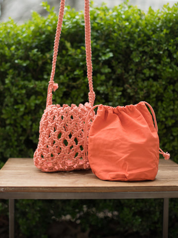 boho chic hand woven macrame open knit small crossbody coral orange bag with drawstring closure and removable inner bag
