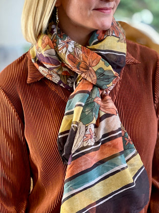 a flower patterned scarf in jewel tones perfect to wrap around your neck or drape across your shoulders