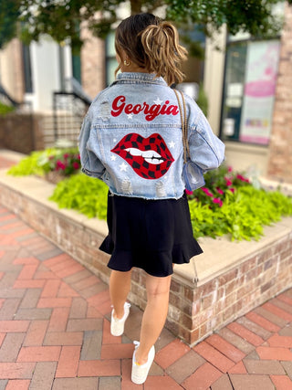 Georgia distressed denim jacket with checkered red and black lips on back full outfit