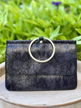 a black bracelet bag in faux python fabric with gold accents perfect for everyday wear and fall winter fashion
