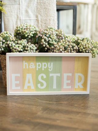 Multi colored pastel wood plank sign reads Happy Easter