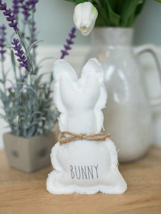 adorable white fabric easter bunny with jute neck bow and gray text that reads bunny