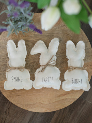 adorable white fabric easter bunnies with jute neck bows and gray text that reads bunny spring easter