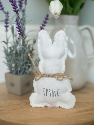adorable white fabric easter bunny with jute neck bow and gray text that reads spring