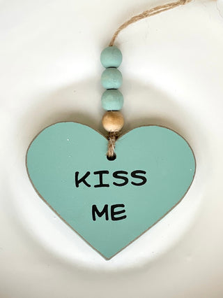 decorate your car or home with this turquoise valentines ornament that reads kiss me with wooden beads as whimsical decor