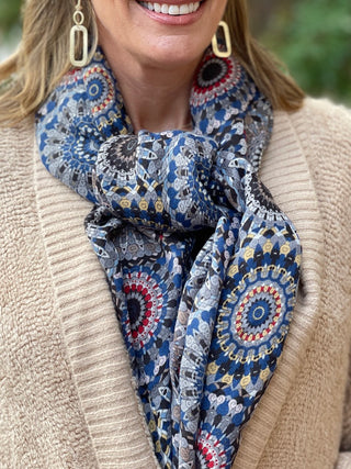 a blue and black patterned scarf with mandalas perfect to wrap around your neck or drape across your shoulders