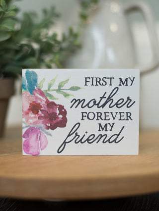 a white block art display with watercolor flowers that reads first my mother forever my friend