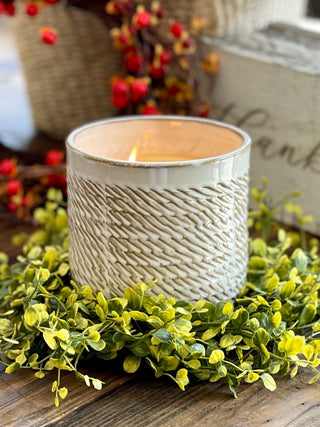 a miniature wreath of faux leaves made to surround a candle perfect for thanksgiving and fall decor centerpieces
