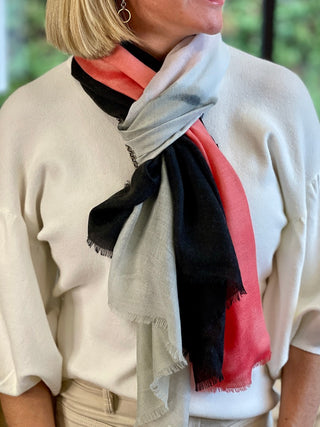 a pink black and gray striped scarf perfect to wrap around your neck or drape across your shoulders