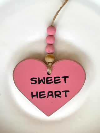 decorate your car or home with this pink valentines ornament that reads sweet heart with wooden beads as whimsical decor