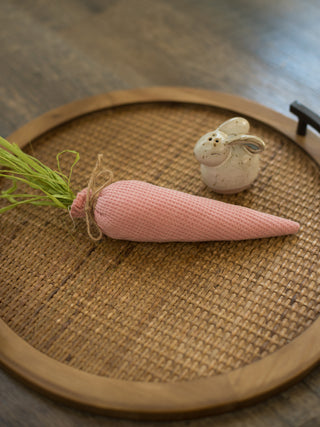 pastel pink stuffed carrot made of waffle weave fabric with green raffia makes adorable easter decor