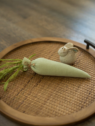 pastel green stuffed carrot made of waffle weave fabric with green raffia makes adorable easter decor