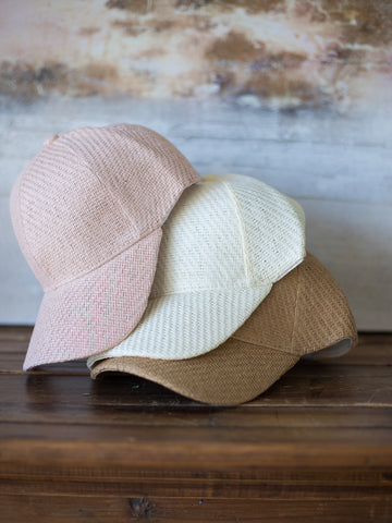 three stacked summery straw baseball caps in neopolitan colors with adjustable velcro closure