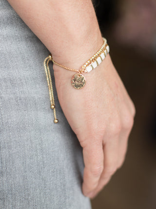 wear this gold and white bracelet with a charm that reads faith as everyday spiritual christian jewelry or give as a gift